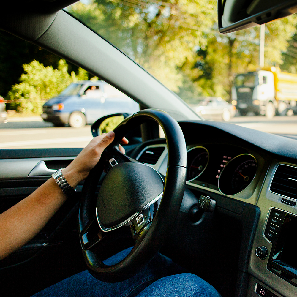 mão-masculina-no-volante-do-automóvel